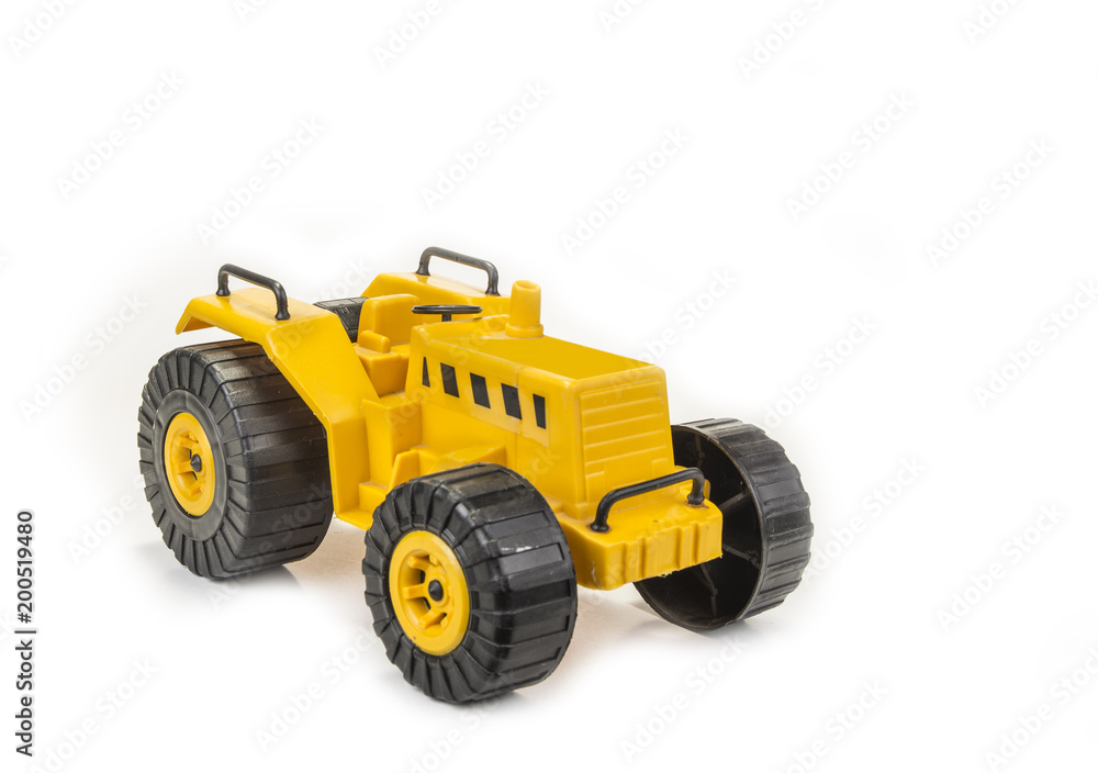 Yellow tractor toy for child on the white background Yellow tractor toy for child on the white background