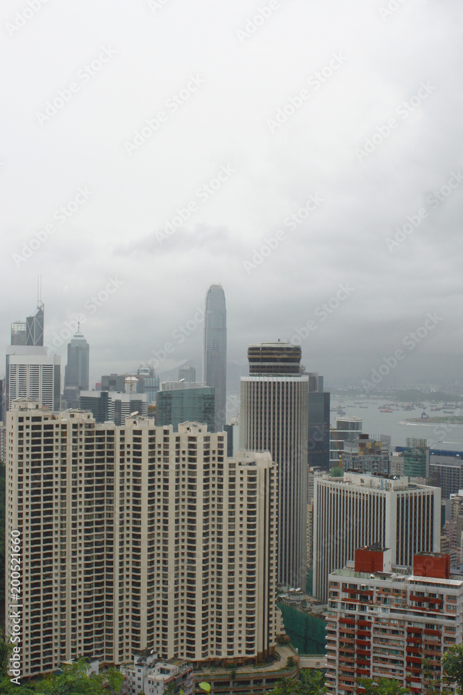 Fototapeta premium Hong Kong: View from Stubbs Road Lookout across Wan chai and Hong Kong Central on a rainy summer day