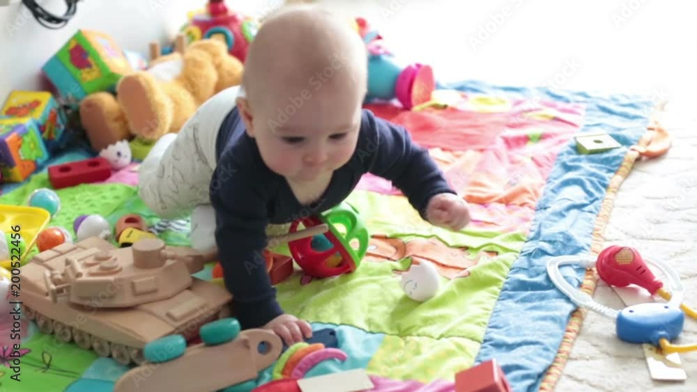 Cute little toddler baby boy, playing at home on the floor in bedroom, smiling happily Cute little toddler baby boy, playing at home on the floor in bedroom, smiling happily