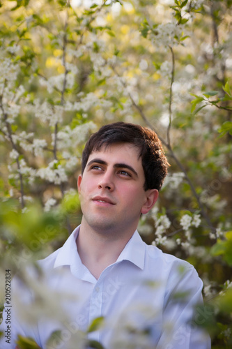 man in blooming spring gardens.