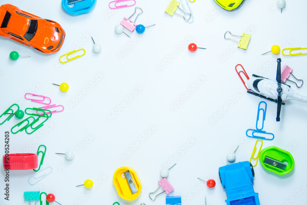 Top view of paper clips with toys on white background Top view of paper clips with toys on white background