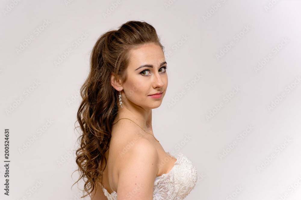 beautiful bride in white wedding dress in different poses on white backgrounds shows her hair beautiful bride in white wedding dress in different poses on white backgrounds shows her hair