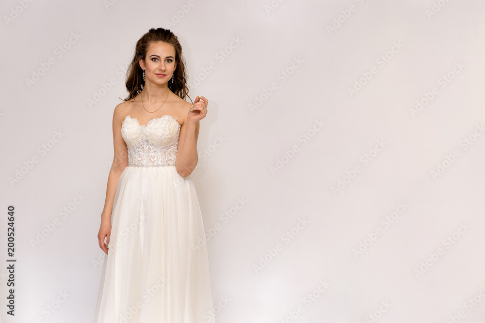 beautiful bride in white wedding dress in different poses on white backgrounds shows different emotions beautiful bride in white wedding dress in different poses on white backgrounds shows different emotions