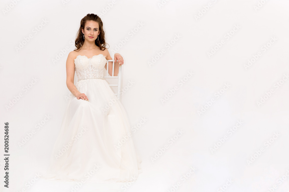 beautiful bride in white wedding dress in different poses on white backgrounds shows different emotions