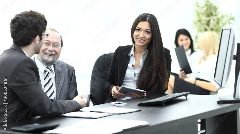 business colleagues at their Desk in the office business colleagues at their Desk in the office