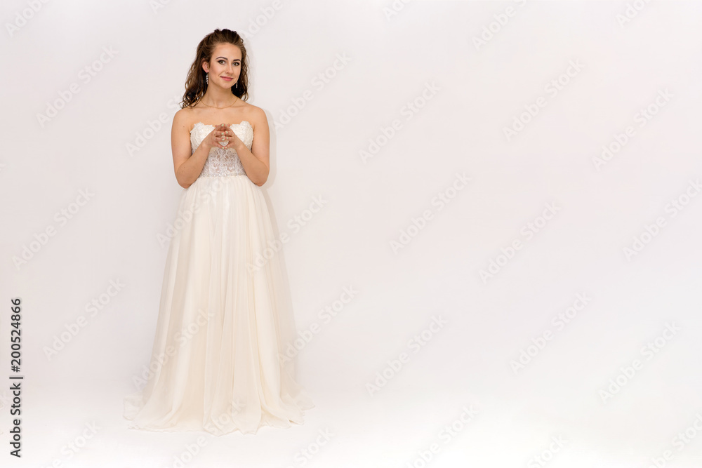 beautiful bride in white wedding dress in different poses on white backgrounds shows different emotions beautiful bride in white wedding dress in different poses on white backgrounds shows different emotions