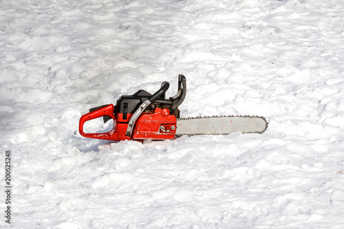 white ice stands with a red chainsaw