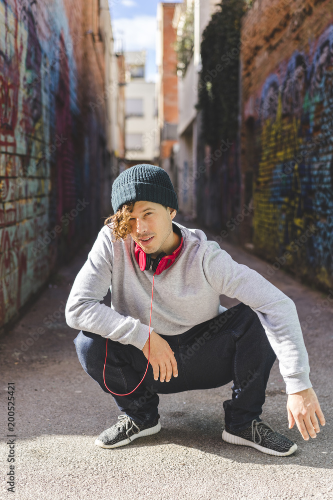 Portrait of young man with headphones wearing wool cap Portrait of young man with headphones wearing wool cap