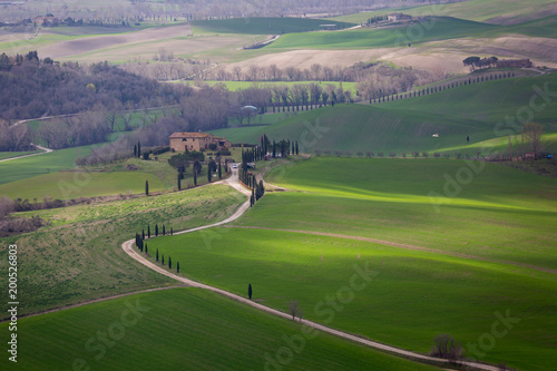 Tuscany, Italy. Spring landscape with rolling hills and green meadow.