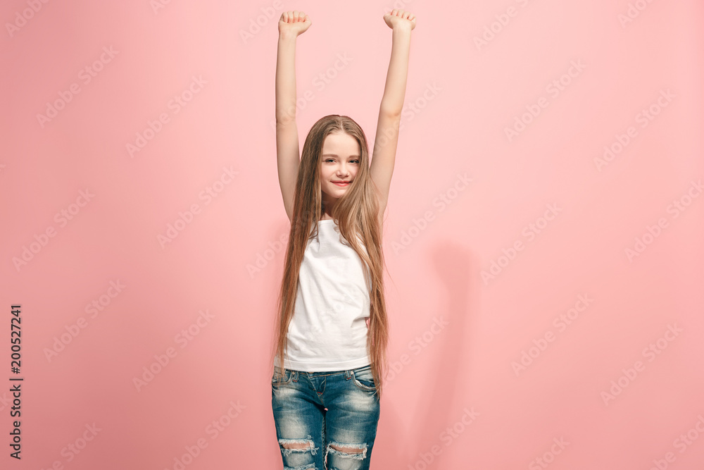 Happy success teen girl celebrating being a winner. Dynamic energetic image of female model Happy success teen girl celebrating being a winner. Dynamic energetic image of female model