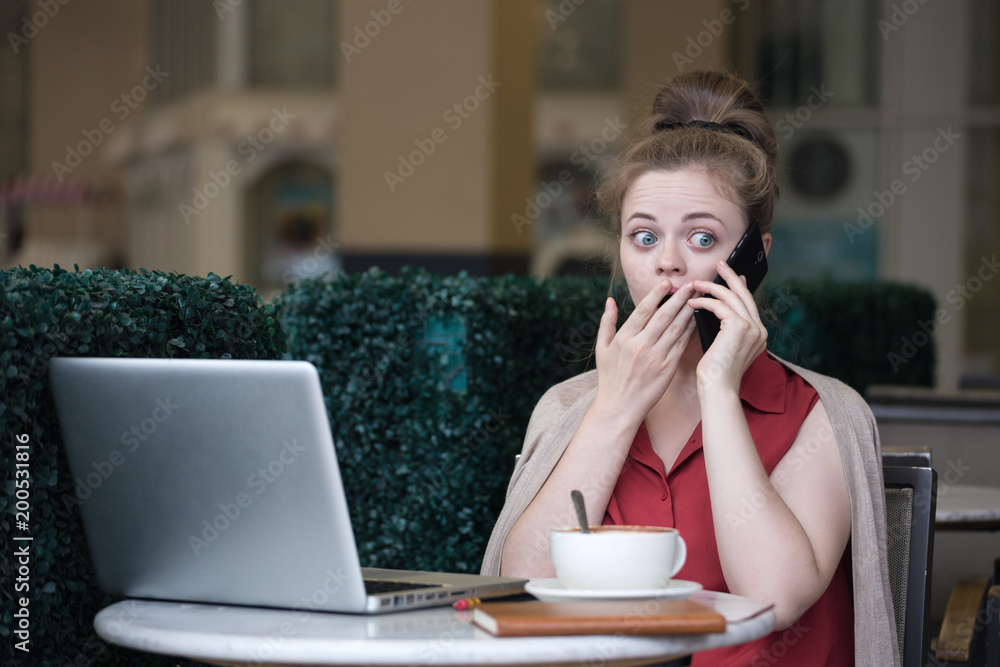 Young caucasian woman with smartphone getting bad news, looks shocked Young caucasian woman with smartphone getting bad news, looks shocked