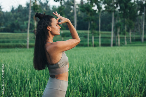 brünette Frau macht Yoga im Reisfeld photo