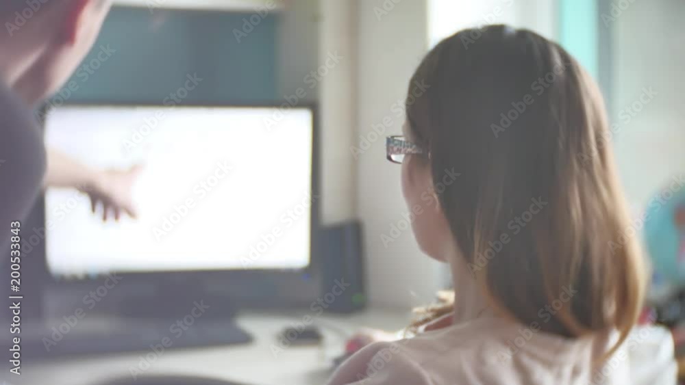 Concentrated couple of young colleagues working in modern office. Two coworkers discussing their work, working with documents. man and woman working in the office at the computer free form of clothing Concentrated couple of young colleagues working in modern office. Two coworkers discussing their work, working with documents. man and woman working in the office at the computer free form of clothing