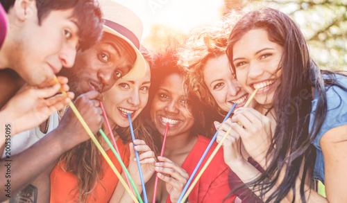 Group of happy friends enjoying drink outdoor at summer party photo