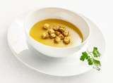 pea soup puree with croutons decorated with parsley