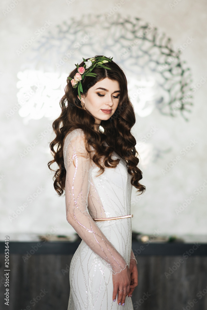 Obraz premium Portrait of the bride, who is waiting for the groom. Brunette Woman with Long and shiny Curly Hair. Beautiful Model Lady with Curly Hairstyle. Hair Care and Beauty products. Care and Beauty of Hair.