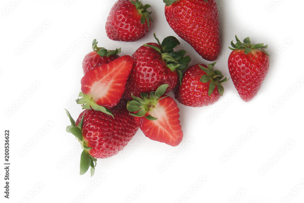 Whole and half strawberries isolated on white background