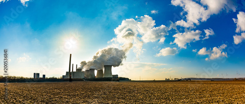 Coal fired power plant with smoking cooling towers photo