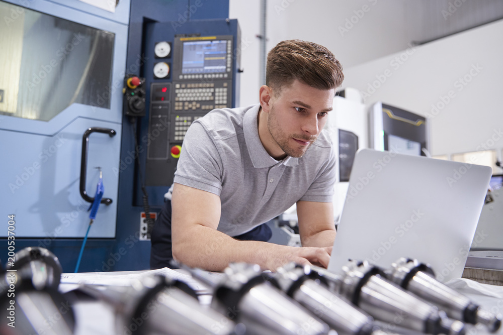 Male Engineer Using CAD Programming Software On Laptop Male Engineer Using CAD Programming Software On Laptop