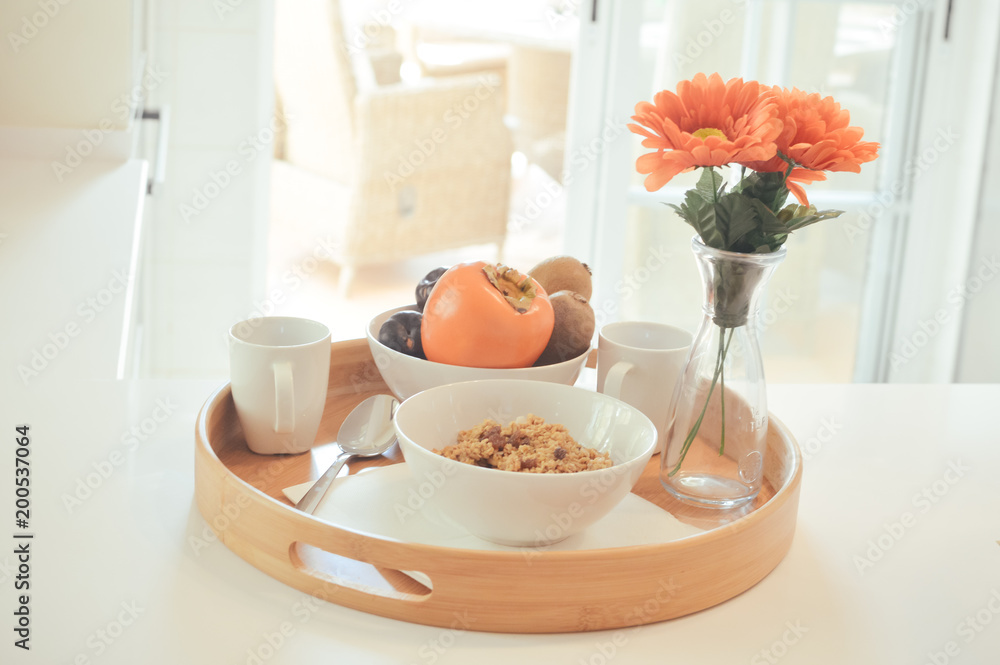 Breakfast on tray served with coffee and fresh flowers on light table background, closeup grocery nutritious balanced diet Breakfast on tray served with coffee and fresh flowers on light table background, closeup grocery nutritious balanced diet