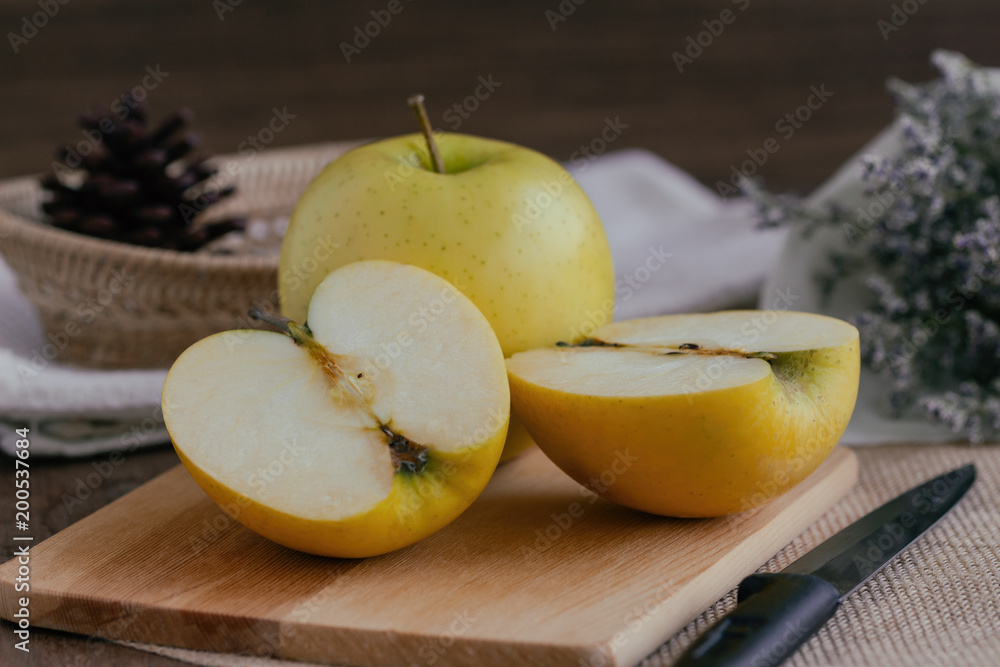 Cross section of fresh Shinano gold apples from Japan put on wooden table with copy space. Delicious taste with sweet,sour,juicy and crisp for snack,salad cooking or make bakery. Healthy fruit concept