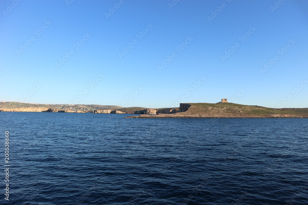 View of the Comino island and Saint Mary tower, Malta