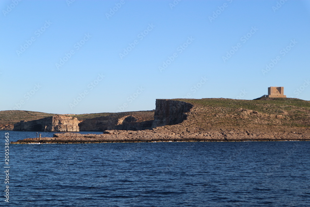 View of the Comino island and Saint Mary tower, Malta