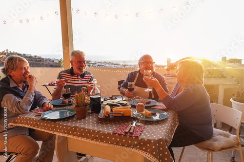 Senior friends having fun doing barbecue dinner in terrace outdoor © DisobeyArt