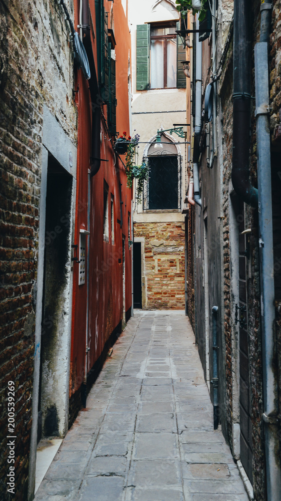 Narrow claustrofobic alley in Venice, Italy