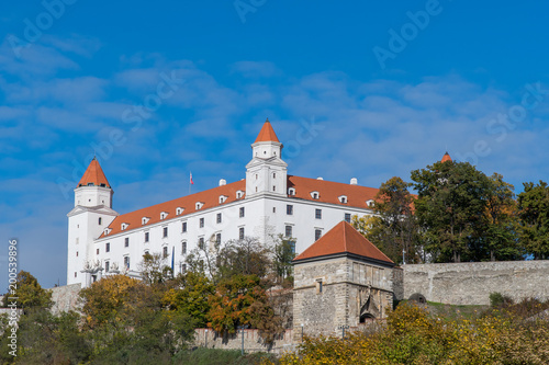 Bratislava Castle seen under blue skies with the famous gatehouse  Sigismund s Gate  in the foreground