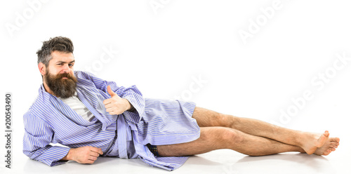 Attractive bachelor concept. Hipster with beard wears bathrobe,