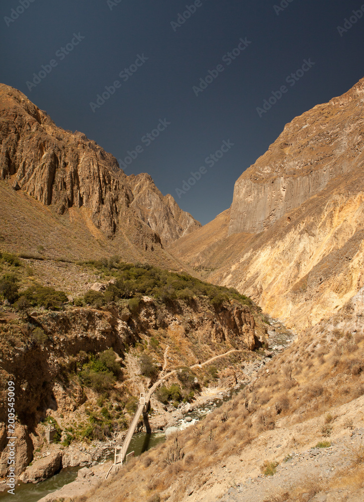 Nice view over the the colca canyon divided by a river Nice view over the the colca canyon divided by a river