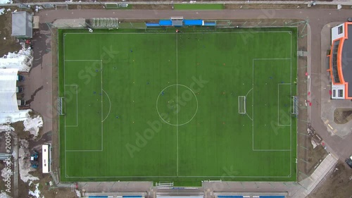 Aerial view of district soccer field with players training on grass