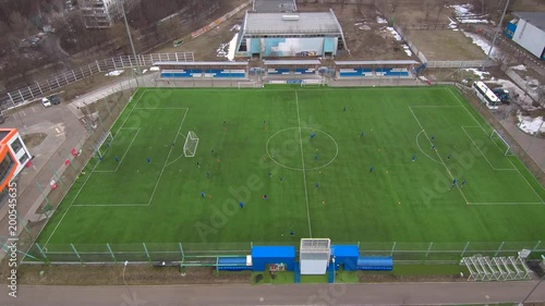 Aerial view of district soccer field with players training on grass