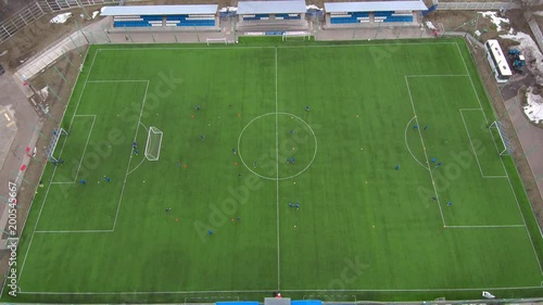 Aerial view of district soccer field with players training on grass