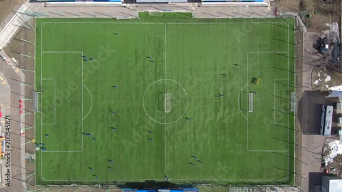 Aerial view of district soccer field with players training on grass