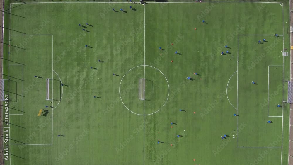 Aerial view of district soccer field with players training on grass Aerial view of district soccer field with players training on grass