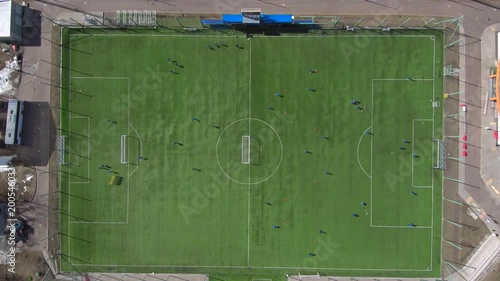 Aerial view of district soccer field with players training on grass