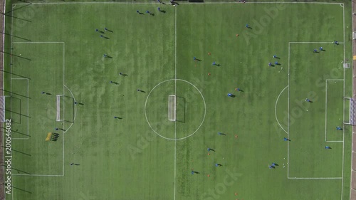 Aerial view of district soccer field with players training on grass