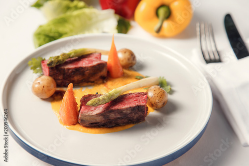 Grilled medium rare steak vegetables on plate