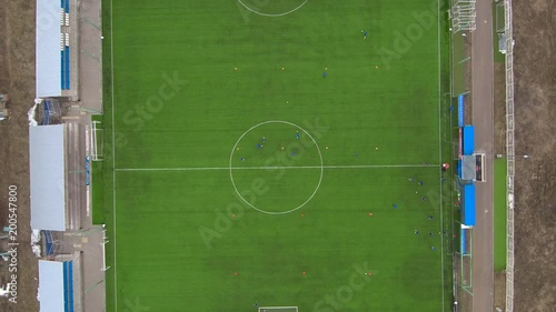 Aerial view of district soccer field with players training on grass