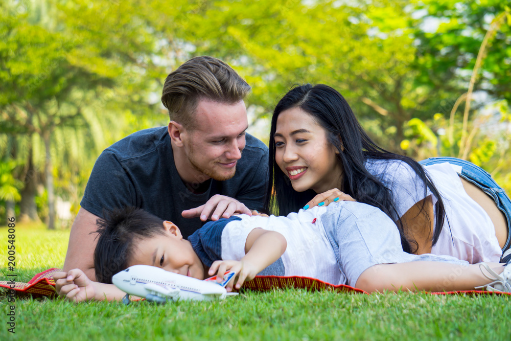 Young family having fun activity outdoors , Happy young family enjoying at the park Young family having fun activity outdoors , Happy young family enjoying at the park