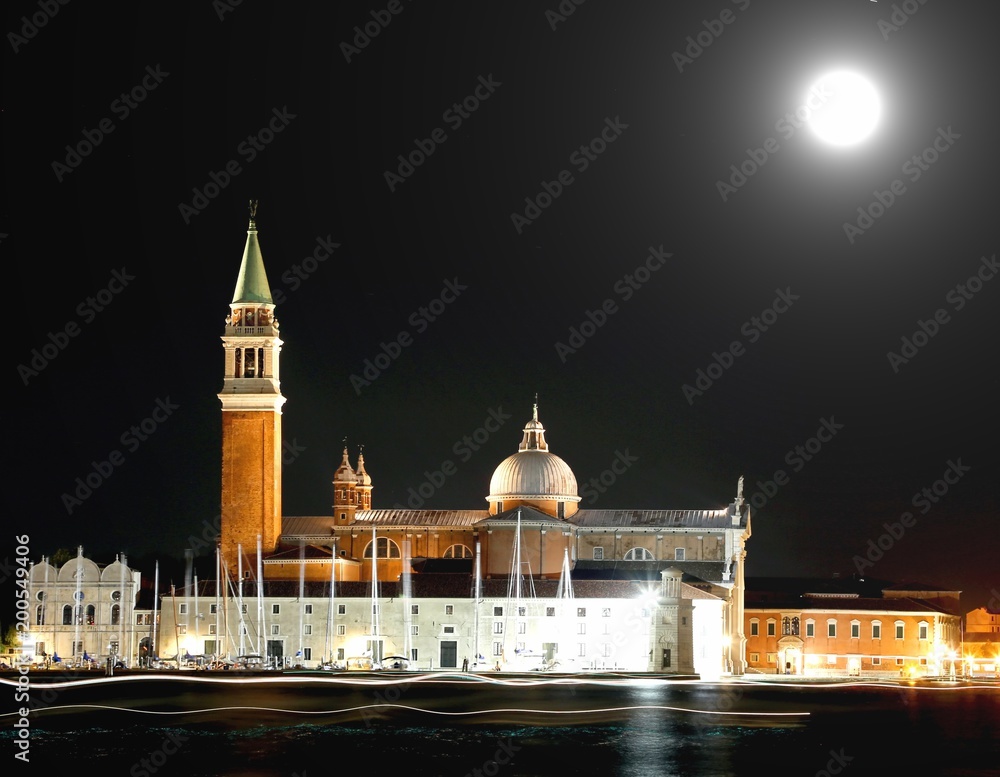 Naklejka premium Church of Saint Geroge in Venice by night and the bright trails left by the passing ships with moon