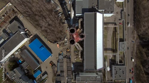 Smoking pipes in industrial zone of the city near residential area. Fly from above