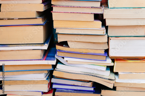 Stack of books background. many books piles.