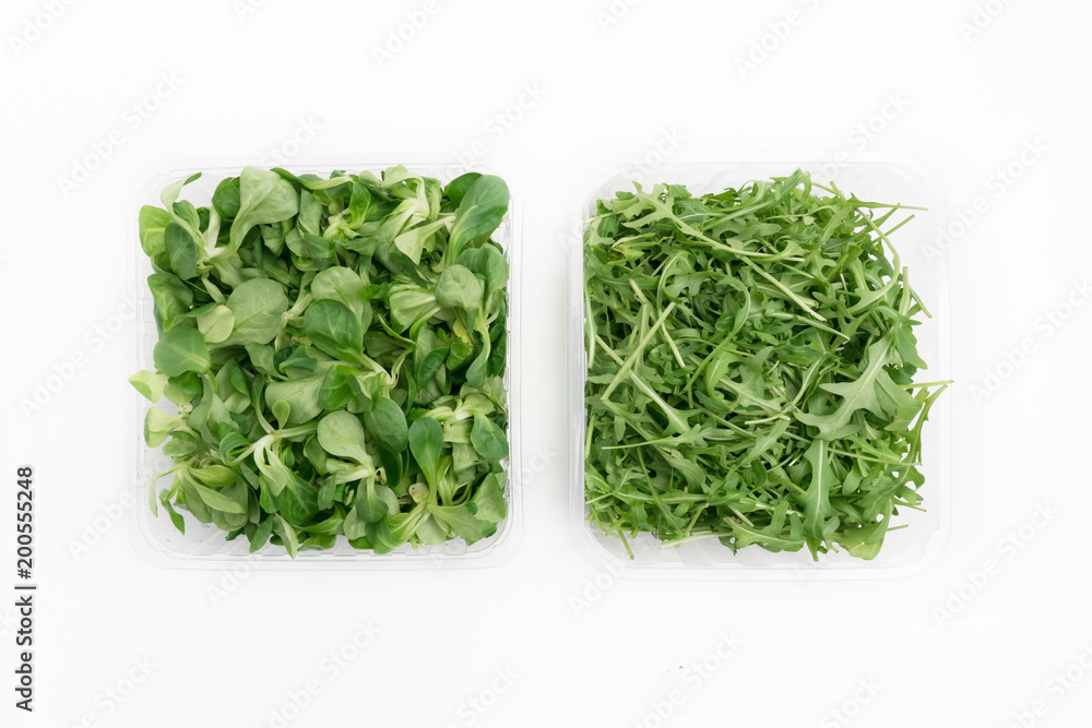 top view of iceberg lettuce and rocket salad in boxes top view of iceberg lettuce and rocket salad in boxes