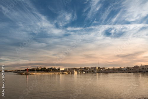 Port and skyline of Trani at sunset