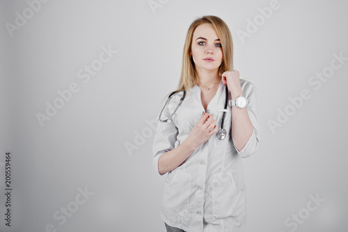 Blonde sexy doctor nurse with stethoscope isolated on white background.