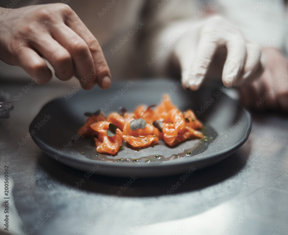 Restaurant Chef cook preparing salmon filet and vegetables Restaurant Chef cook preparing salmon filet and vegetables