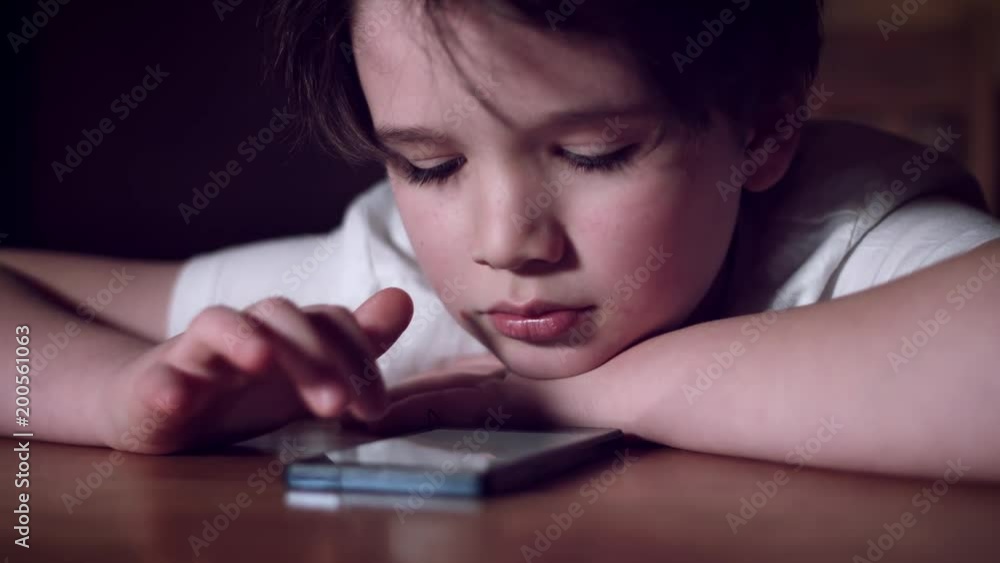4K Tech-Addicted Child Looking in Smartphone 4K Tech-Addicted Child Looking in Smartphone